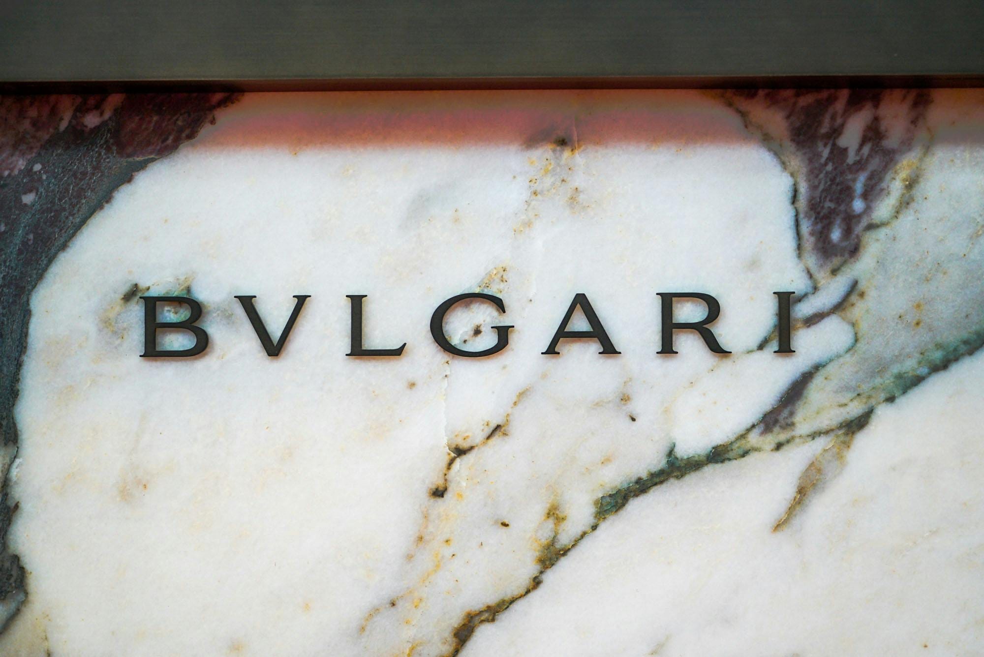 Bvlgari lettering mounted on a veined white-and-purple marble slab