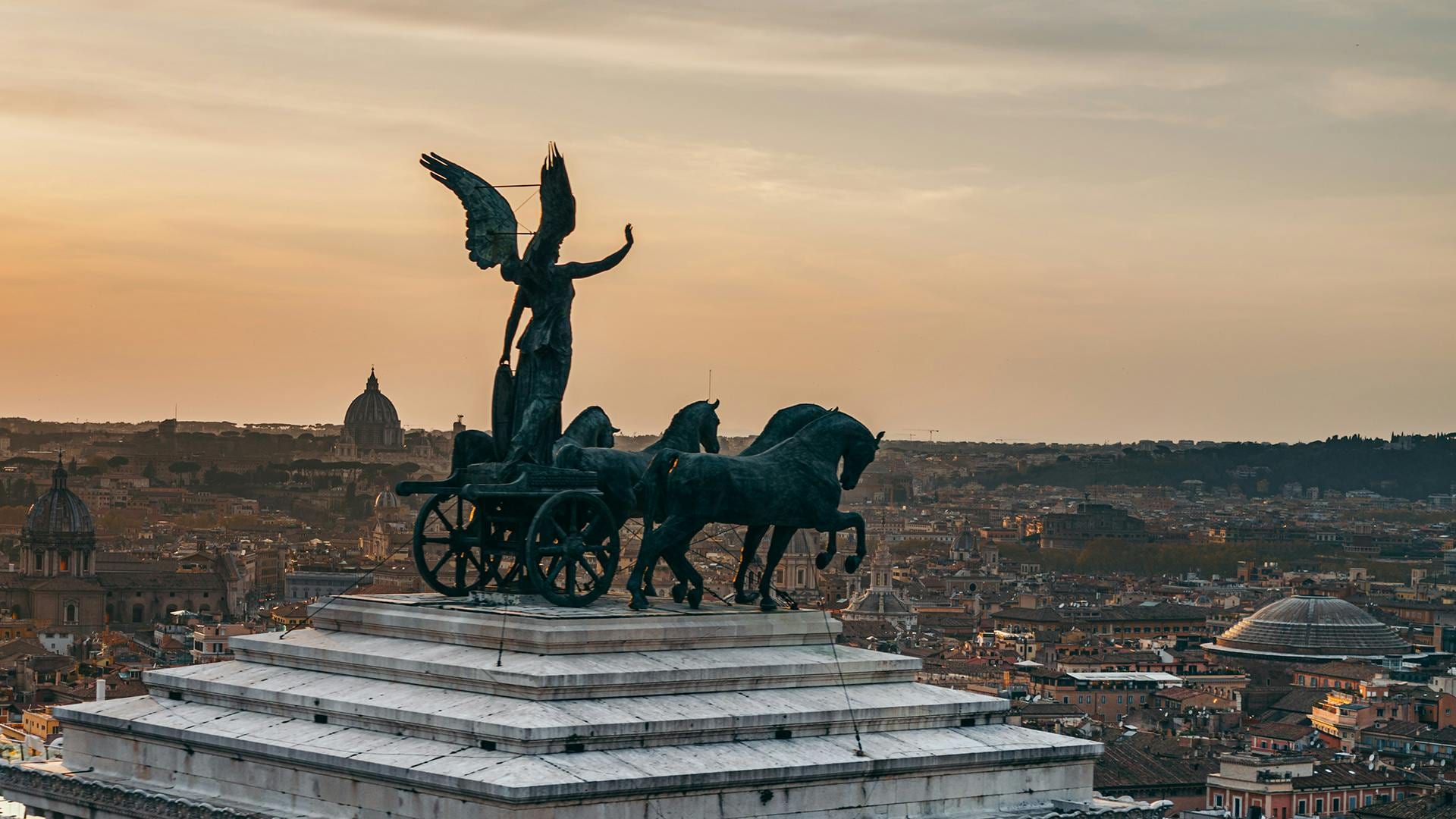 Bronze winged Victory and chariot atop the Vittoriano above Rome at dusk