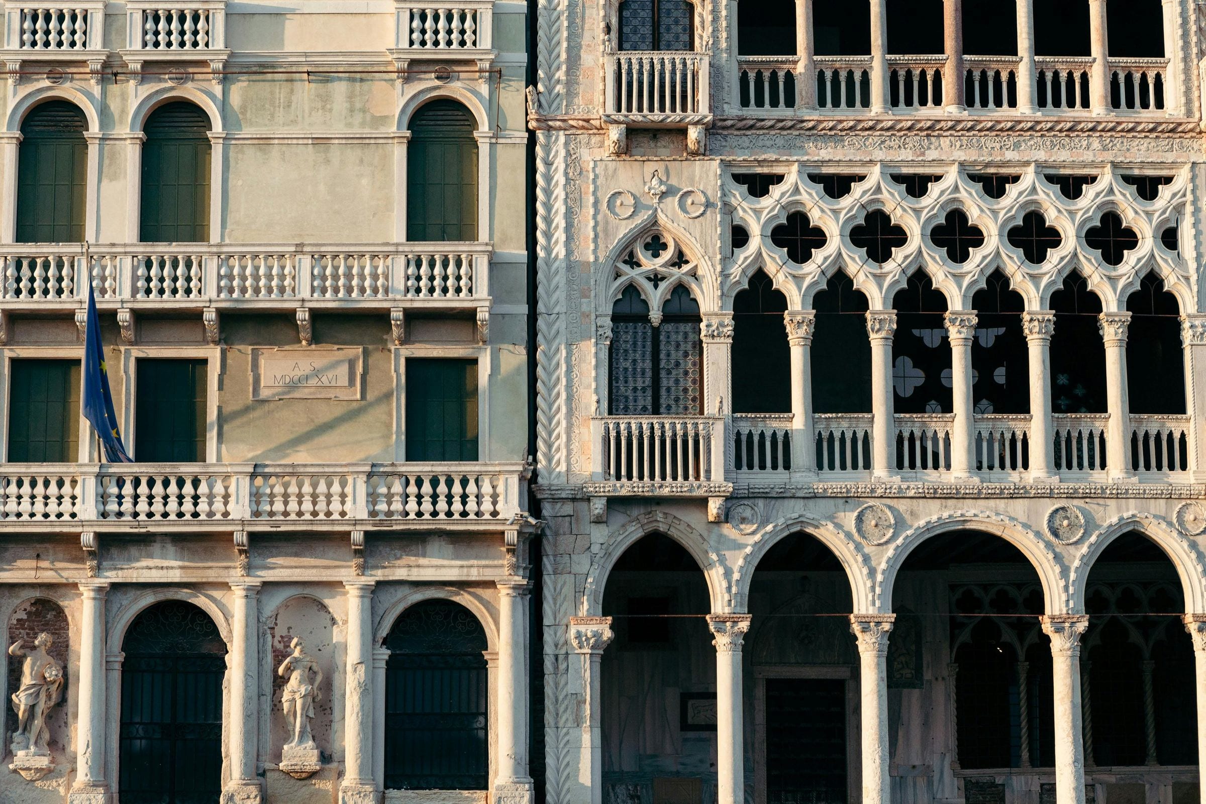Golden-hour close-up of Grand Canal palazzo facades and Ca' d'Oro Gothic tracery
