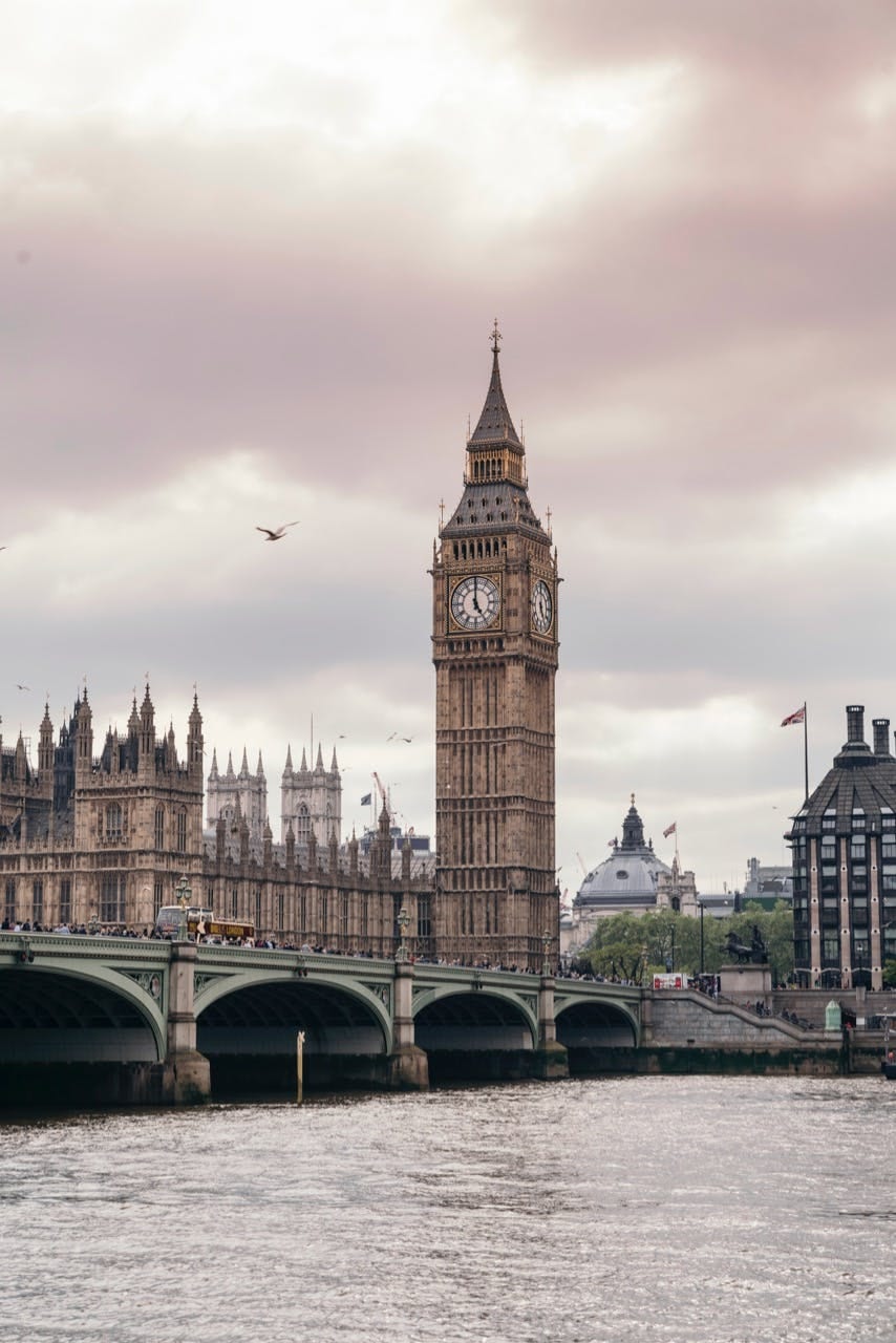Big Ben and Westminster Bridge above the Thames under a soft grey sky